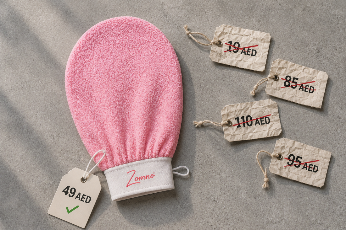 Zomno™ exfoliating glove lying flat on a simple grey stone surface, with two crumpled price tags beside it – one showing 19 AED crossed out, the other showing 49 AED