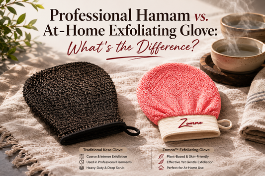 A traditional kese glove (dark coarse fabric) and a Zomno™ exfoliating glove (light beige viscose) lying side by side on a plain linen towel, two small ceramic bowls with steam rising faintly in the background, soft natural light