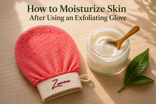 A Zomno™ exfoliating glove lying next to an open glass jar of white cream with a small wooden scoop on a light wood surface, a single green leaf beside the jar, soft morning light